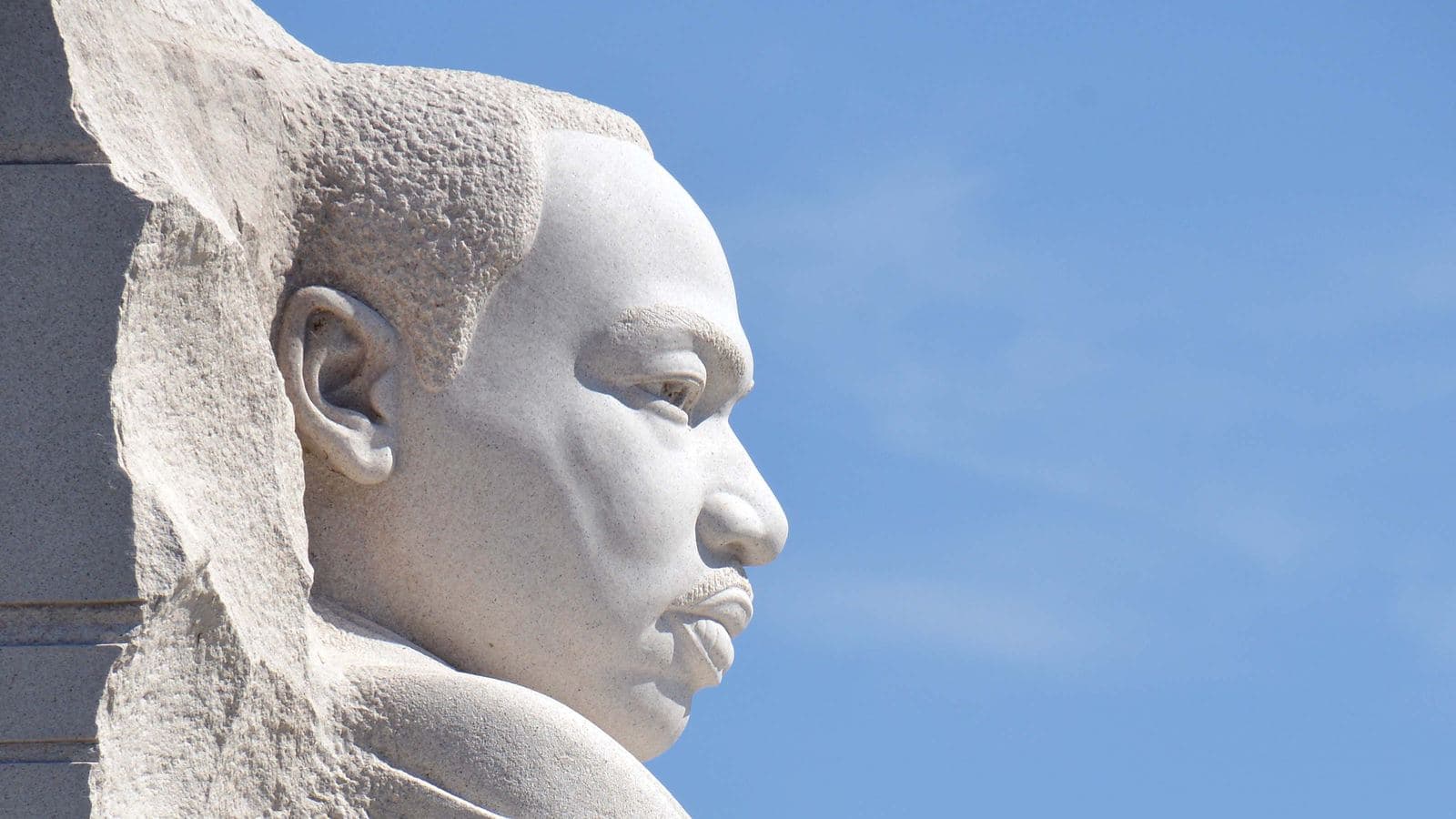 The Martin Luther King, Jr. Memorial statue in Washington, DC against a blue sky