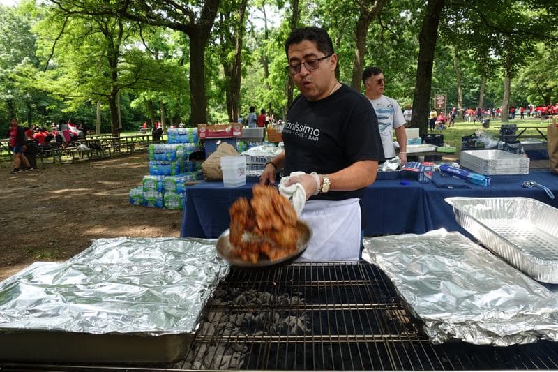 A Richmond Tours staff member grilling at a Field Day BBQ
